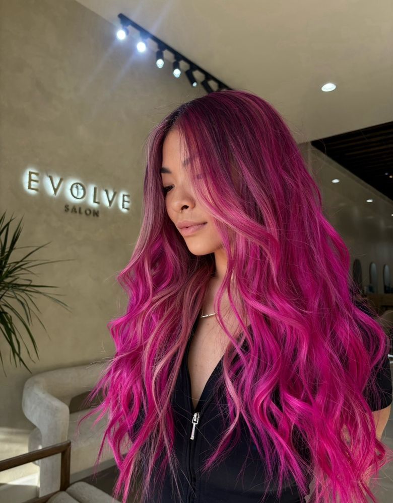Very long vivid magenta pink hair styled in loose textured waves