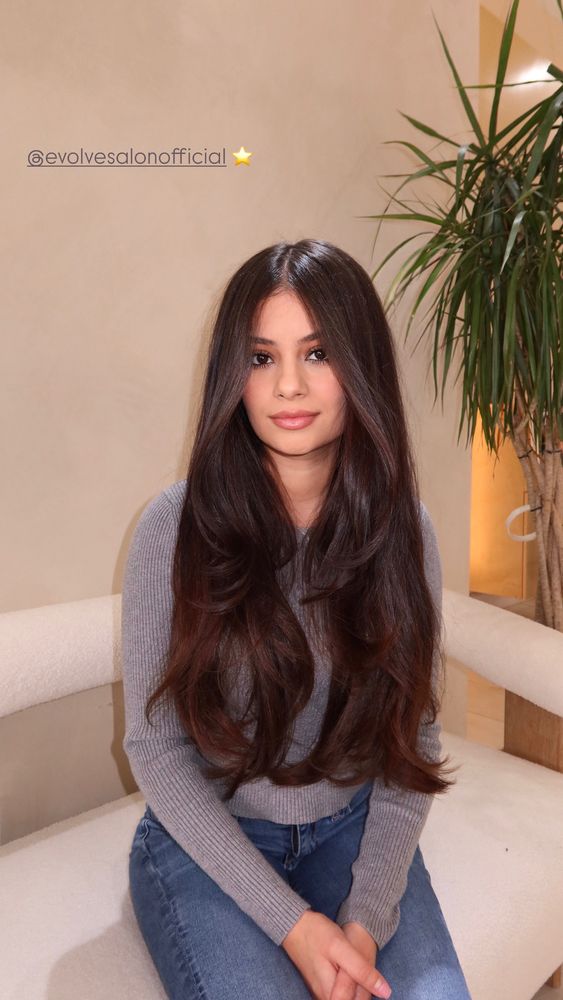 Long mahogany brunette hair with soft waves through the ends